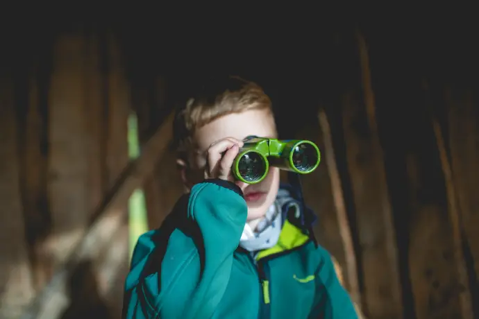 boy using green binoculars